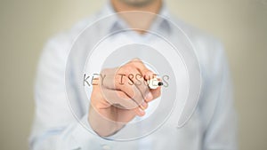 Key Issues , man writing on transparent screen