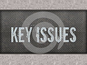 KEY ISSUES painted on metal panel wall.