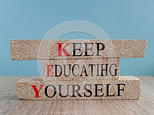 KEY, keep educating yourself symbol. Brick blocks with words \'KEY, keep educating yourself\'.