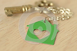 Key with a key chain in shape of a green house - Love for home a