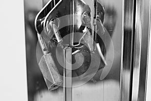 Key lock hanging in the gate hole in black and white color, expressing security feeling