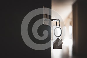 A key in a lock with house icon. process of opening the front door to the apartment