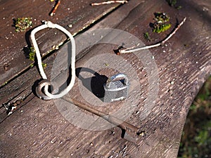 Key and lock on a wooden bench in the forest.