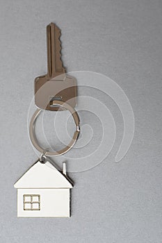 Key with metal house shaped pendant