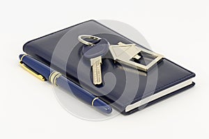 Key, notebook and pen