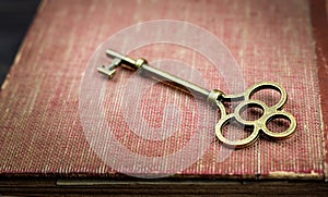 Key on an old book, top secret, confidential background