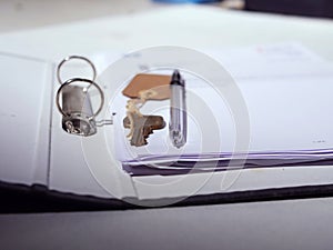 Key with paperwork and pen for property medium shot
