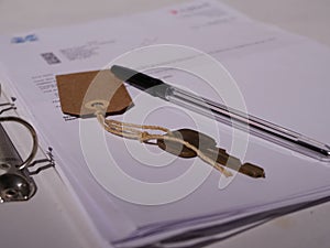 Key with paperwork and pen for property medium shot