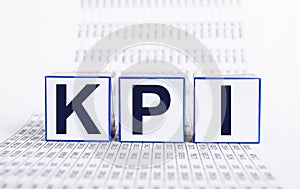 Key performance indicators. KPI letters at cubes and documents with statistics. Evaluation of business objectives