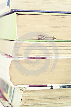 Key on a pile of books instagram effect close-up