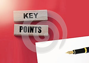 Key Points on cube wooden blocks on red. Business management concept.