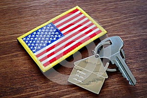 Key from property and USA flag. VA loan mortgage. photo