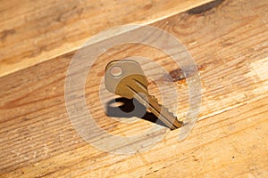 Key stuck in the table. key on a wooden background. safety and security concept