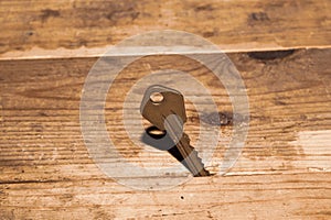 Key stuck in the table. key on a wooden background. safety and security concept