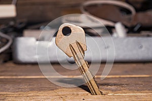 Key stuck in the table. key on a wooden background. safety and security concept