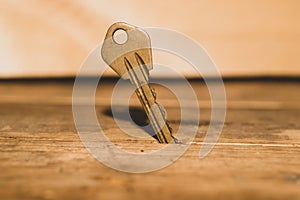 Key stuck in the table. key on a wooden background. safety and security concept