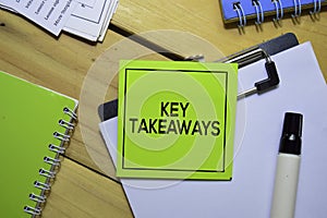 Key Takeaways on sticky Notes isolated on office desk.