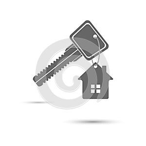 Key to the house. A key with a keychain in the form of a house