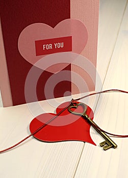 'Key to My Heart' love concept, with gold heart shape key and red heart gift tag