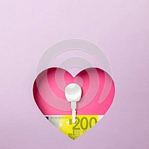 The key and the two hundred euro banknote are in a pink heart on a purple background. Minimal concept of money, love and security