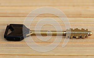 A key on a wooden background close up