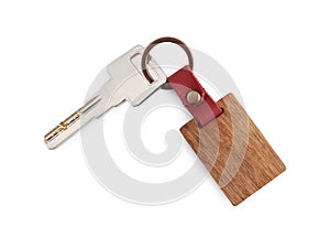 Key with wooden keychain isolated on white, top view
