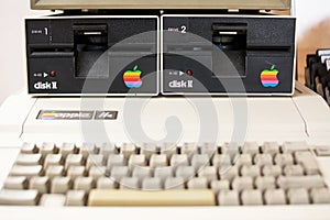 Keyboard blurred and disk drive of Aged Apple computer