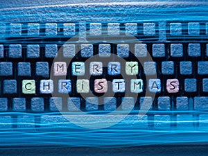 Keyboard colored buttons with words Merry Christmas