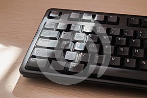 A keyboard on the desk under sunshine light