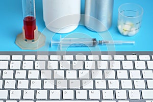 Keyboard with different medical equipment on a blue background