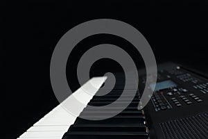 Keyboard of the digital synthesizer on black background