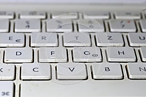 Keyboard on a dirty white laptop