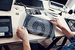 Keyboard of disassembled laptop, repairman pov