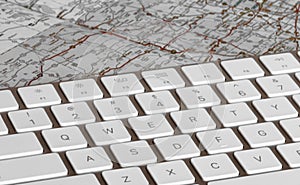 Keyboard with flat paper map showing routes and destinations.