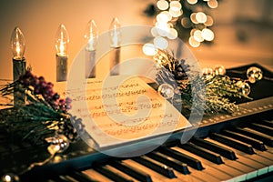 Keyboard with instrumental sheet music and soft lights for Christmas holiday, split tone