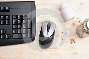 keyboard, mouse and bottles of mental support supplement