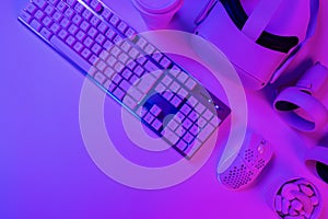 Keyboard with mouse and headphones on blue desk
