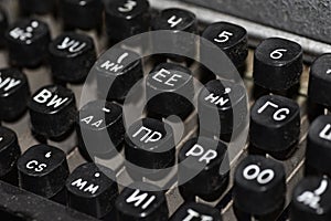 Keyboard of an old Soviet typewriter for spies with Russian and English letters, close-up