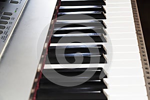 Keyboard piano electronic organ close-up. Hands of musician play on the piano