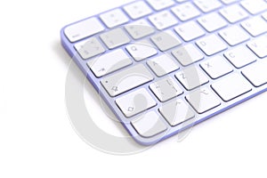 Keyboard purple keys on white table left blur
