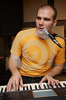 Keyboarder playing near microphone