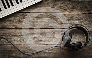 Keyboards and headphones on rustic wooden table