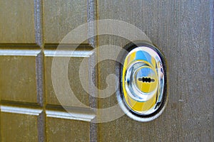 Keyhole on the front door. Close-up. Concept: intrusion protection