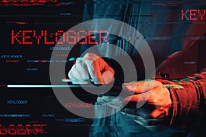 Keylogger concept with faceless hooded male person photo