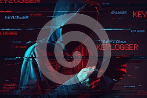 Keylogger concept with faceless hooded male person photo