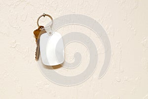 Keyring with key and fob on wall