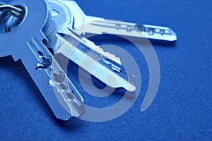 Keyring with keys in blue tone over an empty background