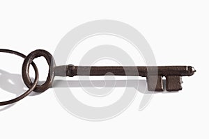 Keyring with old rusty key on white background