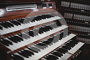 Keys and buttons on a big old brown church organ