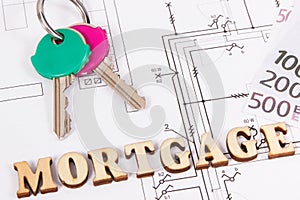 Keys, currencies euro and inscription mortgage on construction diagrams, buying or building house concept